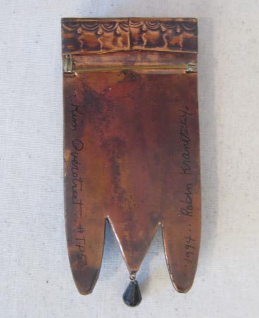 Back of brooch showing signature
