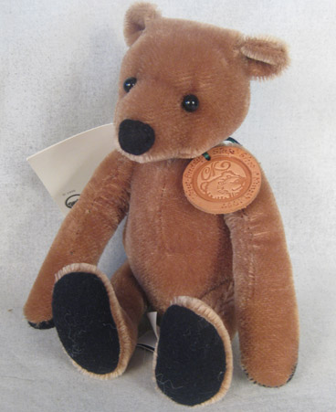 Light browm teddy bear with black felt nose and paw pads