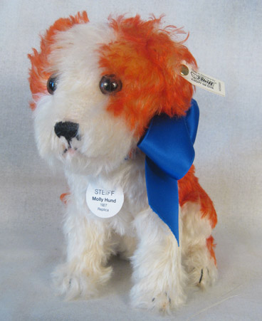 Seated fluffy white dog with orange spots