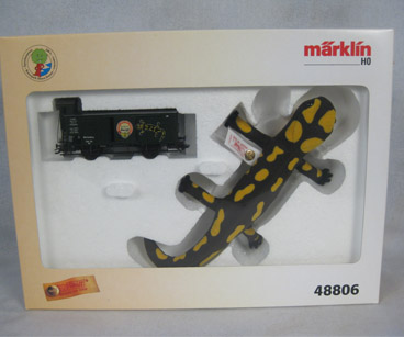 Boxed Steiff salamander with yellow spots with a train car