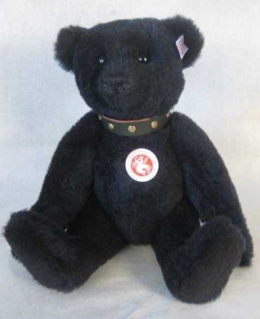Dark blue alpaca bear with studded green collar