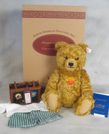 Golden blond teddy bear with passport, suitcase, and accessories