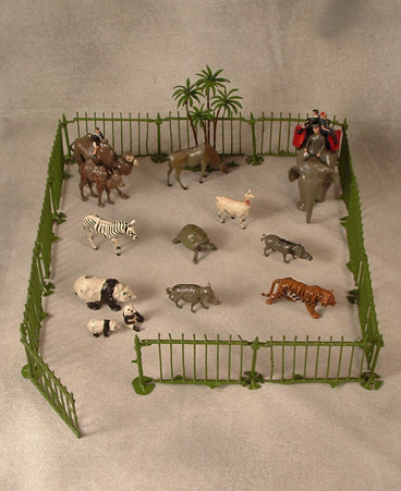 24Z: elephant with keeper, howdah & 2 children, camel with boy & baby camel, llama, zebra, eland bull, tiger, wart hog, wild boar, giant tortoise, panda & 2 cubs, date palm and fencing (missing 8 pieces) $650.00