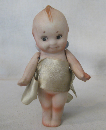 3.5 inch Nippon Kewpie-type with ribbon.
